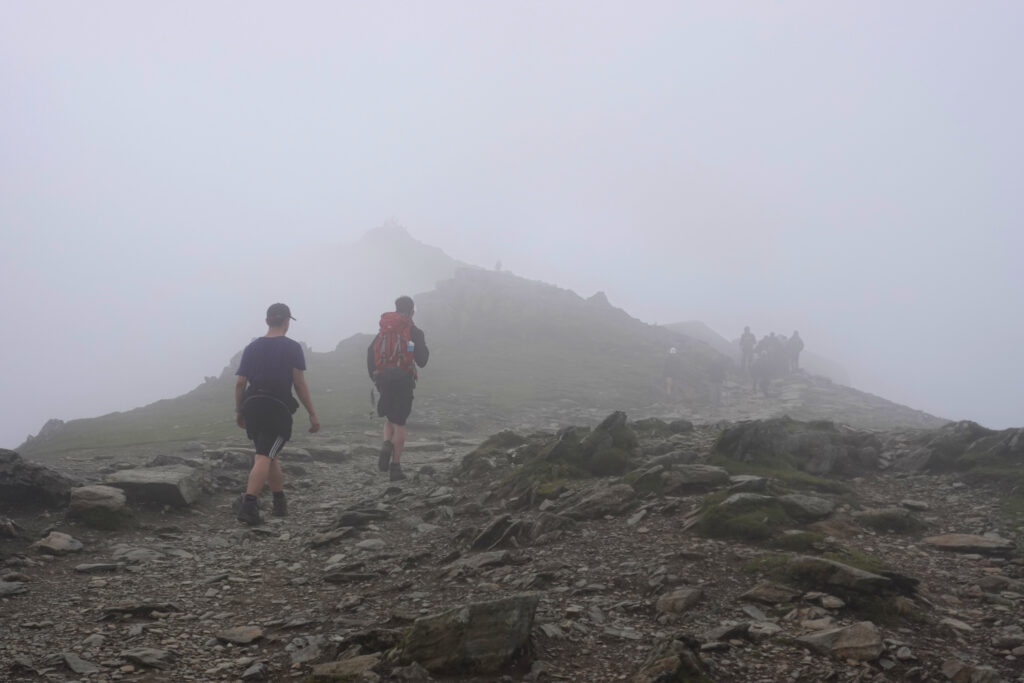 Hikers walking into fog